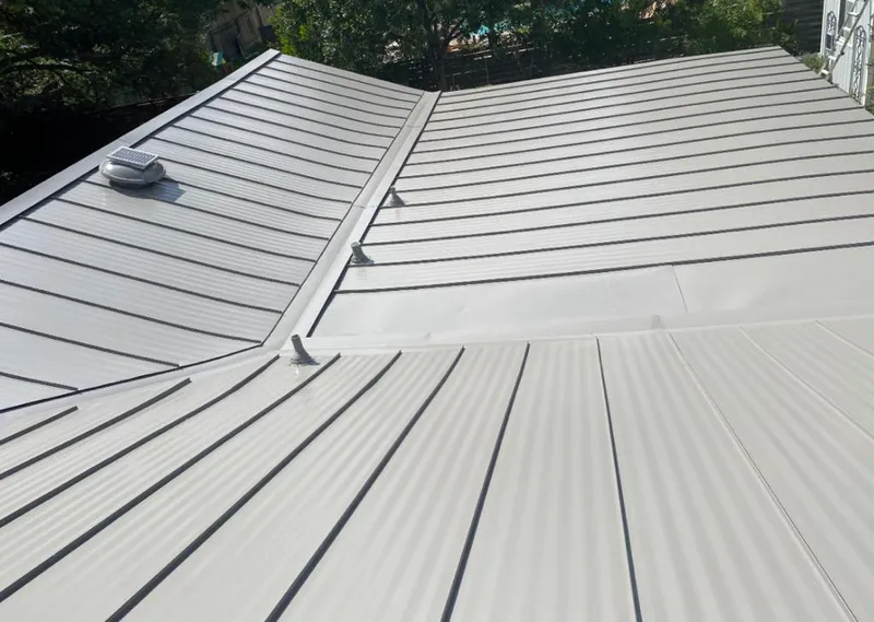 Solar attic fan installed on a metal roof for Roof Ventilation in Hudson Falls